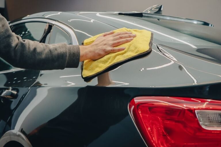 Hand buffing car paint with a yellow microfiber