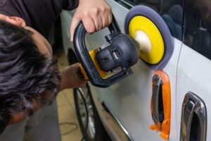 Orbital polisher on a white car door