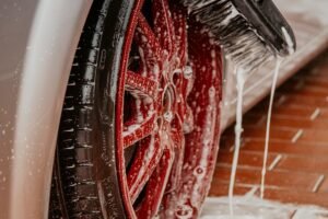 Brush cleaning and polishing a car wheel